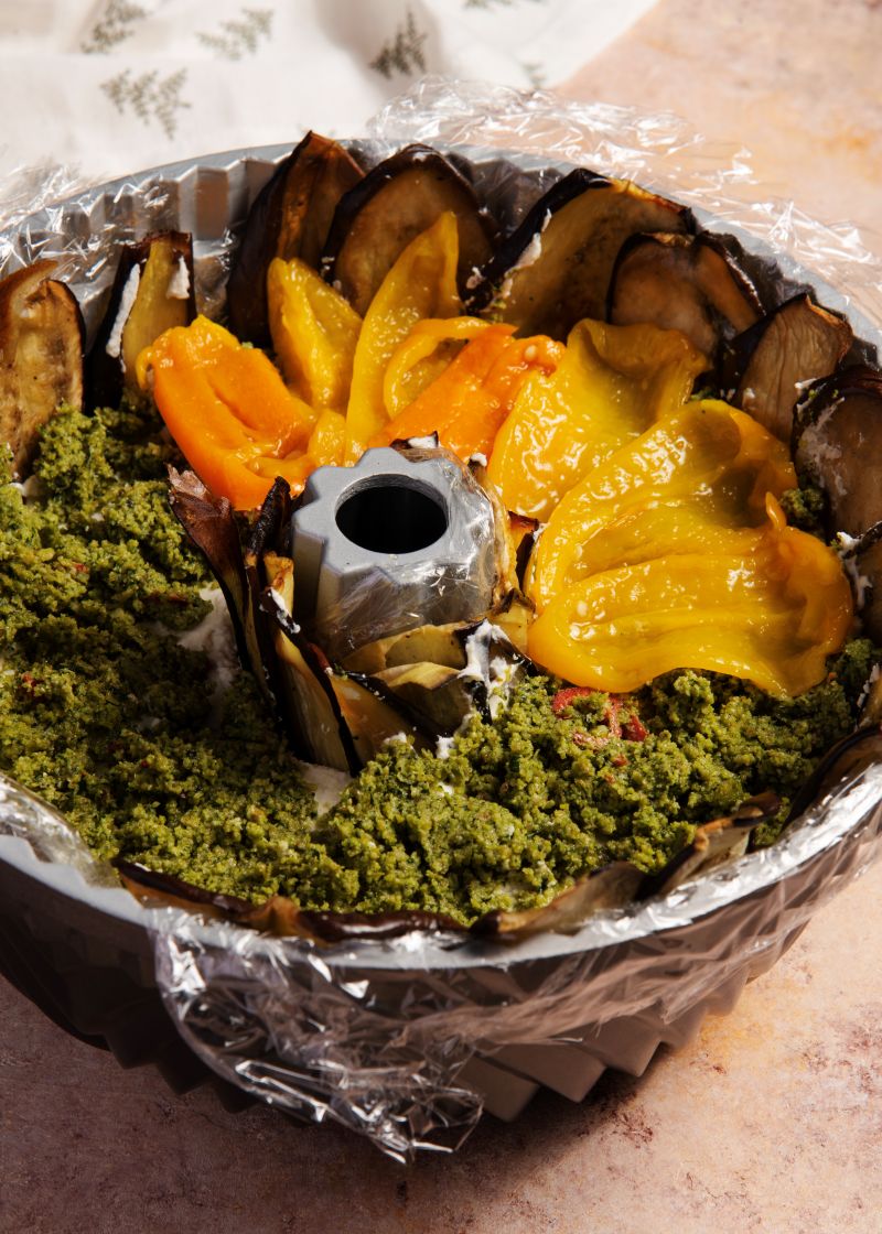 რულეტის ასაწყობად გვირგვინის ფორმის კექსის ყალიბში ჩავაფინოთ რამდენიმე ფენა პლასტიკი, ჩავალაგოთ ჯერ კანგაცლილი ტკბილი წიწაკები, შემდეგ ბადრიჯანი, ნადუღი, დარჩენილი ტკბილი წიწაკები, ნიგვზის პასტა და გადავაფაროთ ბადრიჯნის ნაჭრები. შევინახოთ მაცივარში რამდენიმე საათით.